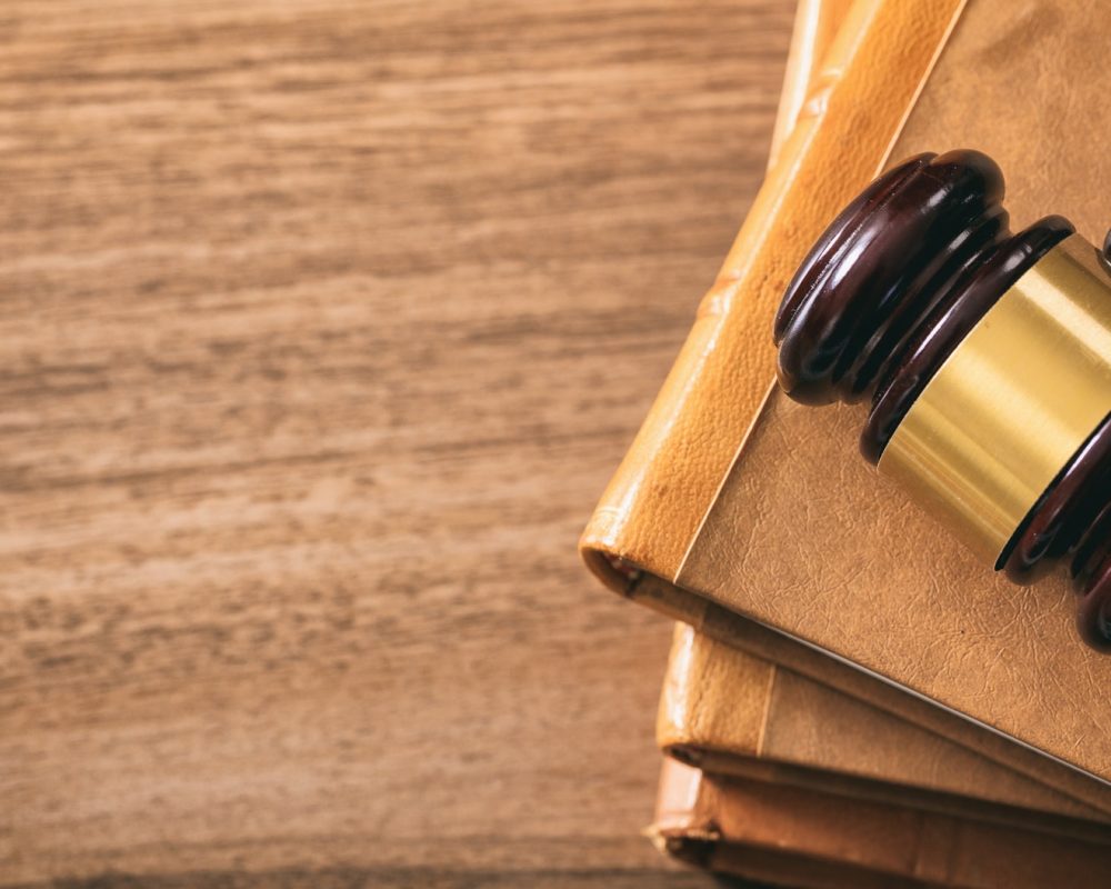 judge-gavel-on-law-books-wooden-desk-top-view.jpg